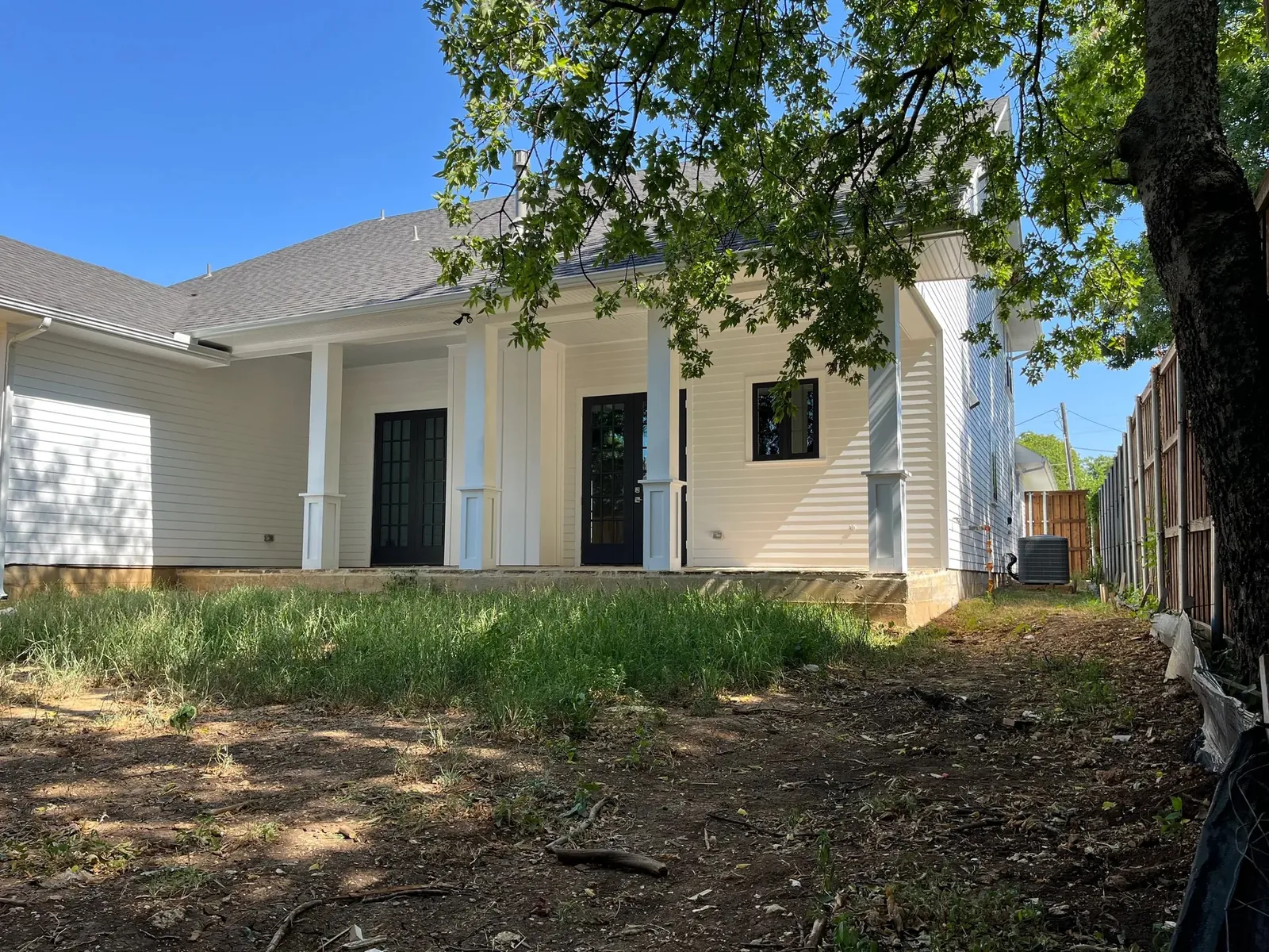 River-rock landscape bed and plantings at a North Texas home, Godoy's Wolves