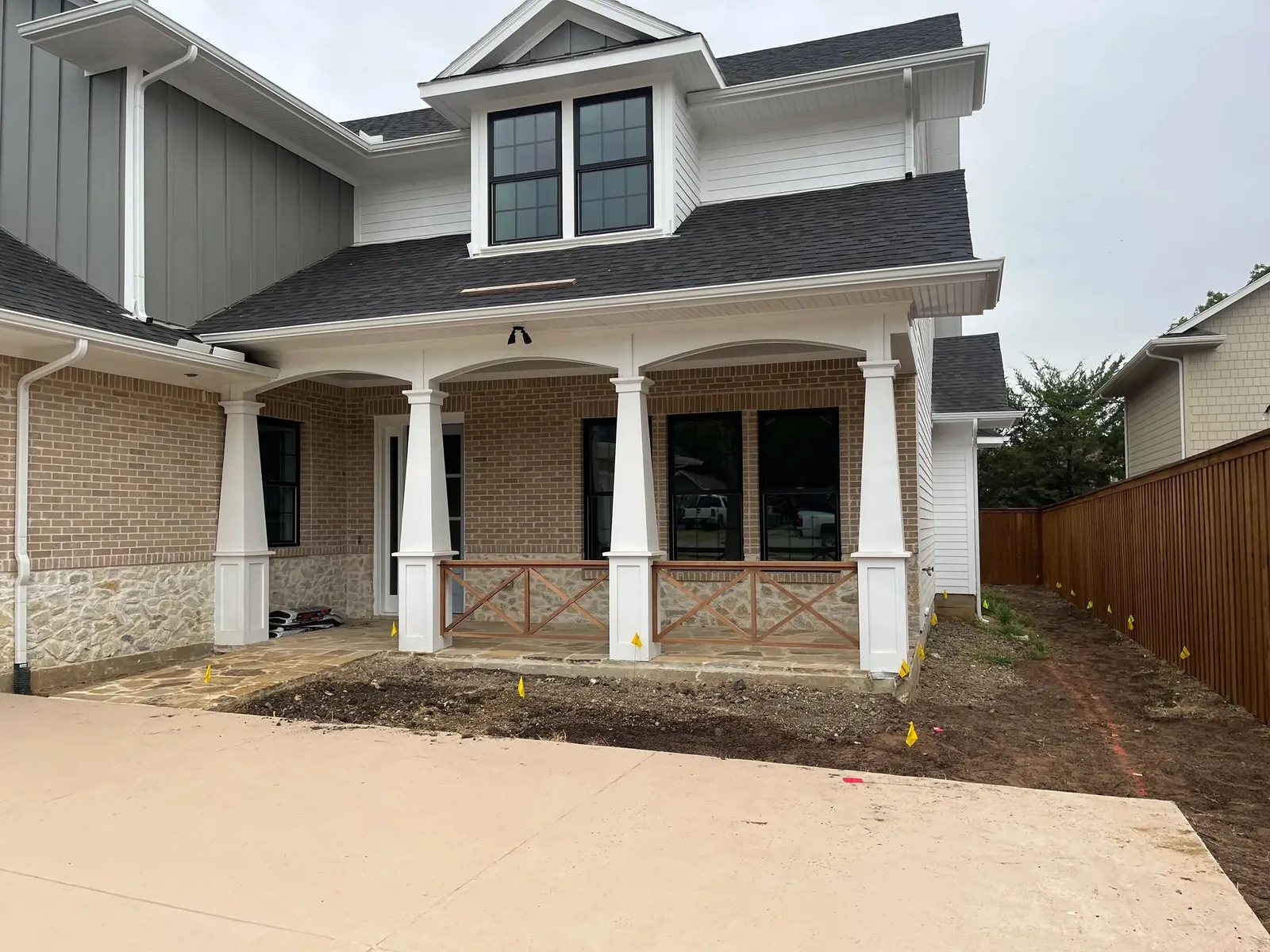 Bare graded dirt lot at a new-construction home before landscaping
