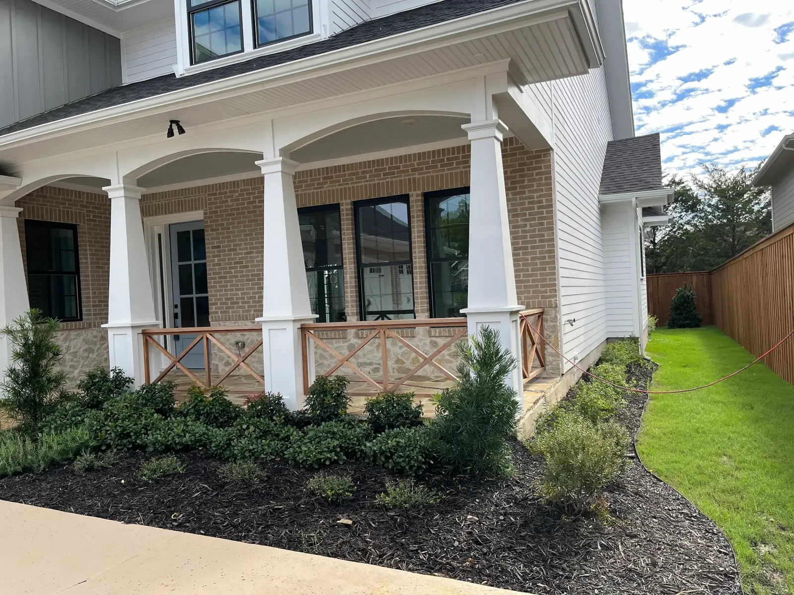 Newly built home with sod, shrubs, and mulch beds installed by Godoy's Wolves