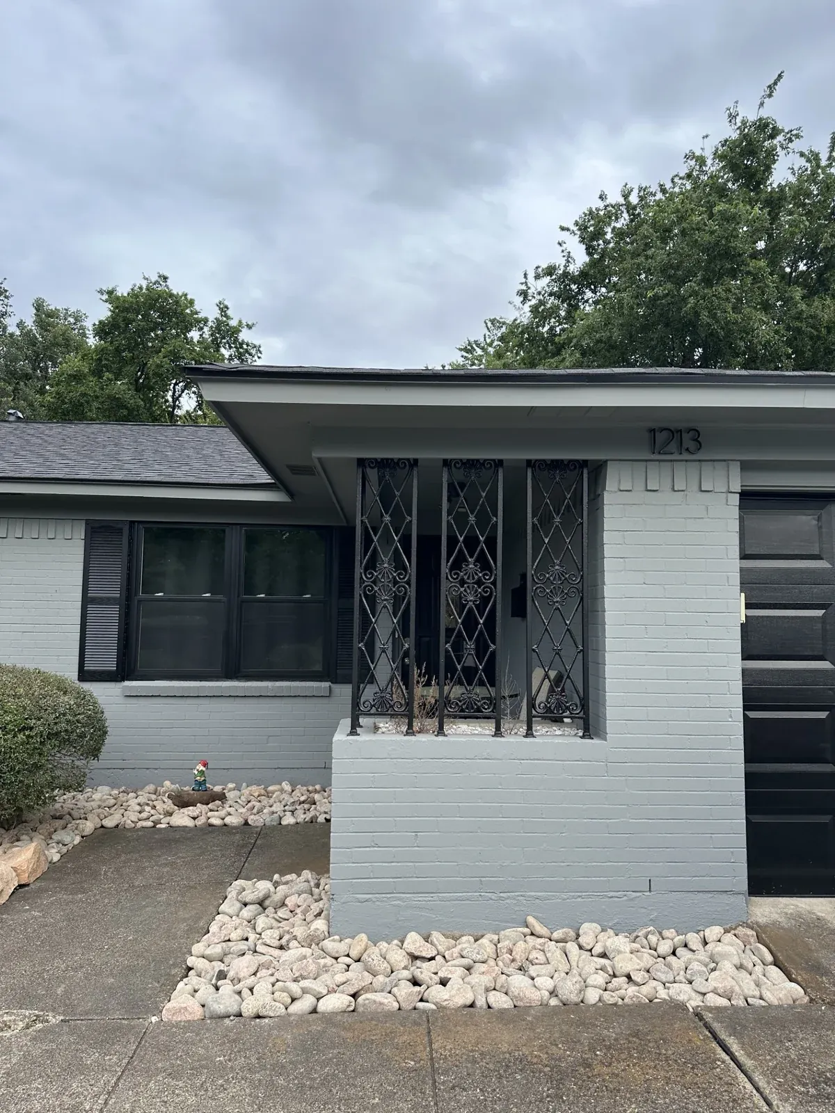 River rock bed gray brick home, Godoy's Wolves